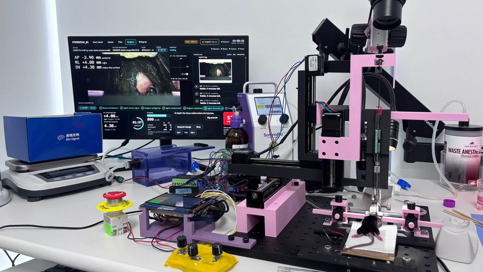 Exin Therapeutics' motorized surgery rig: a needle arm over an anesthetized mouse, a dashboard showing target coordinates, and a red emergency stop button